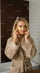Woman Relaxing with Gold Eye Patches for Skin Rejuvenation and Beauty