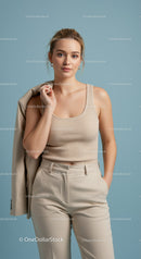 Elegant Woman in Beige Outfit Posing Against Light Blue Background