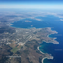 Aerial View of a Large Lake with Mountain Range and Coastal City