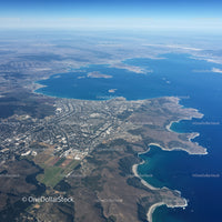 Aerial View of a Large Lake with Mountain Range and Coastal City