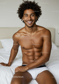 Happy young man relaxing on bed in comfortable underwear