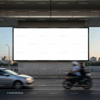 Urban street with blank billboard and moving traffic