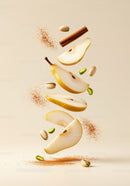Floating sliced pear with cinnamon and pistachio nuts