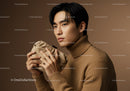 Elegant Young Man in Brown Turtleneck Holding Beige Clutch Professional Portrait