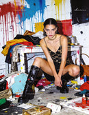 Fashion model posing bold in vibrant messy studio