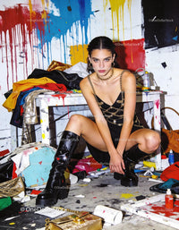 Fashion model posing bold in vibrant messy studio