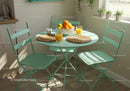 Cozy breakfast nook with mint green table and chairs