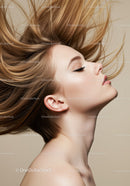 Profile of peaceful woman with flowing hair against beige background