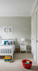 Bright Nursery Room with White Bed and Colorful Wall Art
