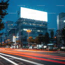 City street at night with light trails and blank billboard