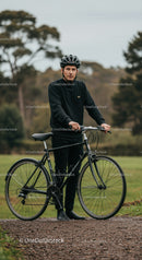 Man with bicycle standing on park trail in autumn
