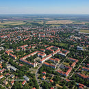 Aerial View of Suburban Neighborhood with Red Roofs and Green Parks