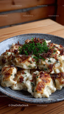 Golden Baked Dumplings with Herbs on Dark Ceramic Plate