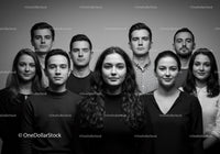 Serious young adults standing closely in black and white