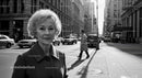 Elegant Elderly Woman Walking in Business District on City Street