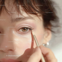 Woman Applying Eye Shadow Using Makeup Brush