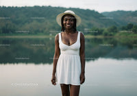 Beautiful Woman in White Dress with Wide-Brim Hat by Lake