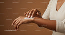 Woman Applying Moisturizer on Hands in a Skincare Routine