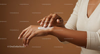 Woman Applying Moisturizer on Hands in a Skincare Routine