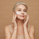 Elegant Mature Woman Applying Skincare Cream with Facial Care