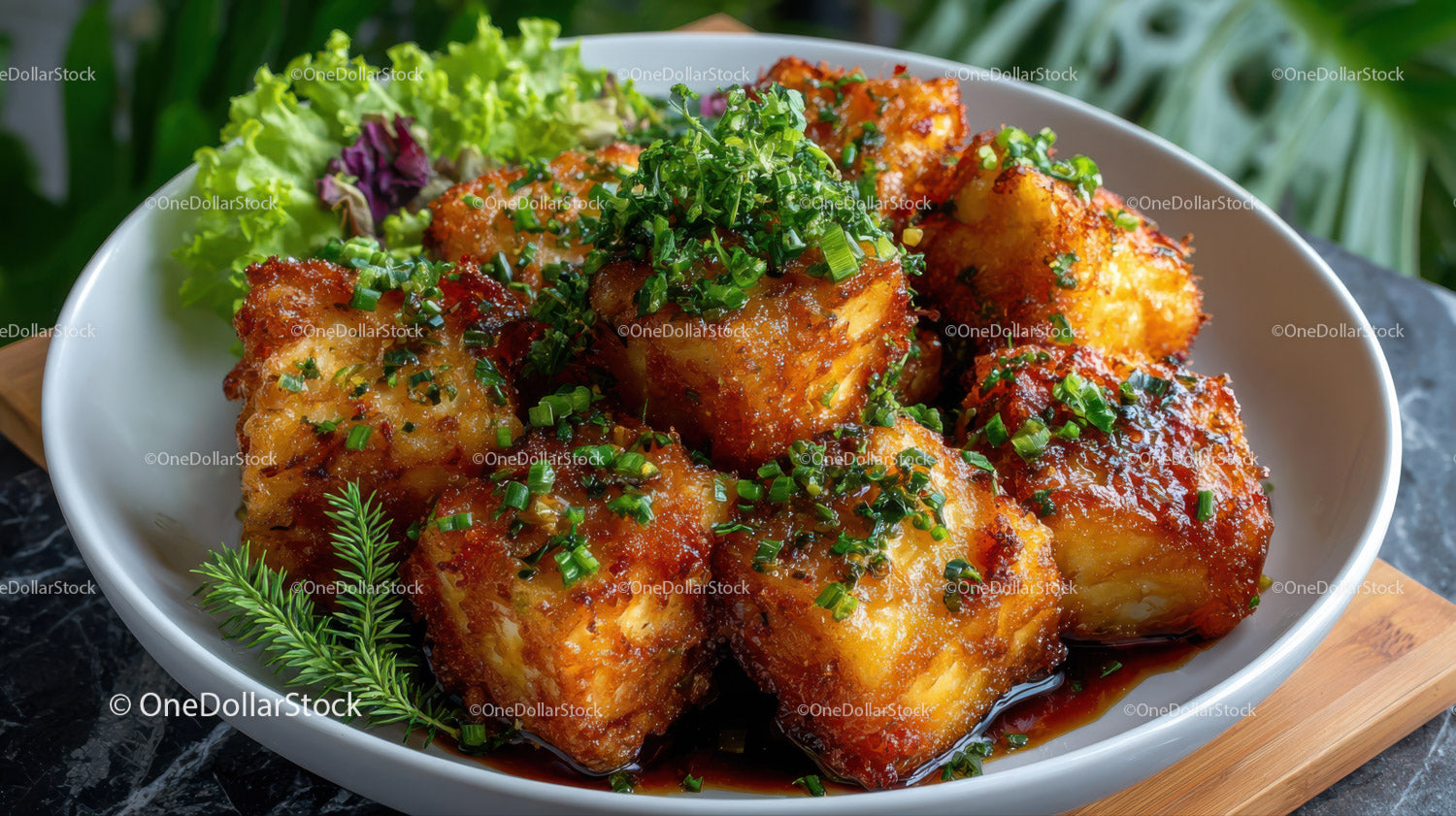Crispy Glazed Chicken with Chives and Leafy Greens on a White Plate