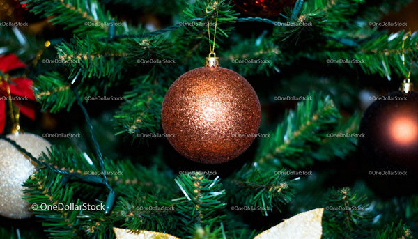 Close-Up of Sparkling Copper Ornament on Christmas Tree