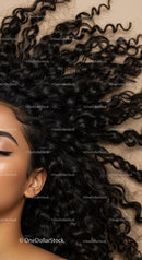 Close up of a woman with curly hair and glowing skin