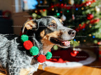 Happy dog with festive pom pom collar near Christmas tree