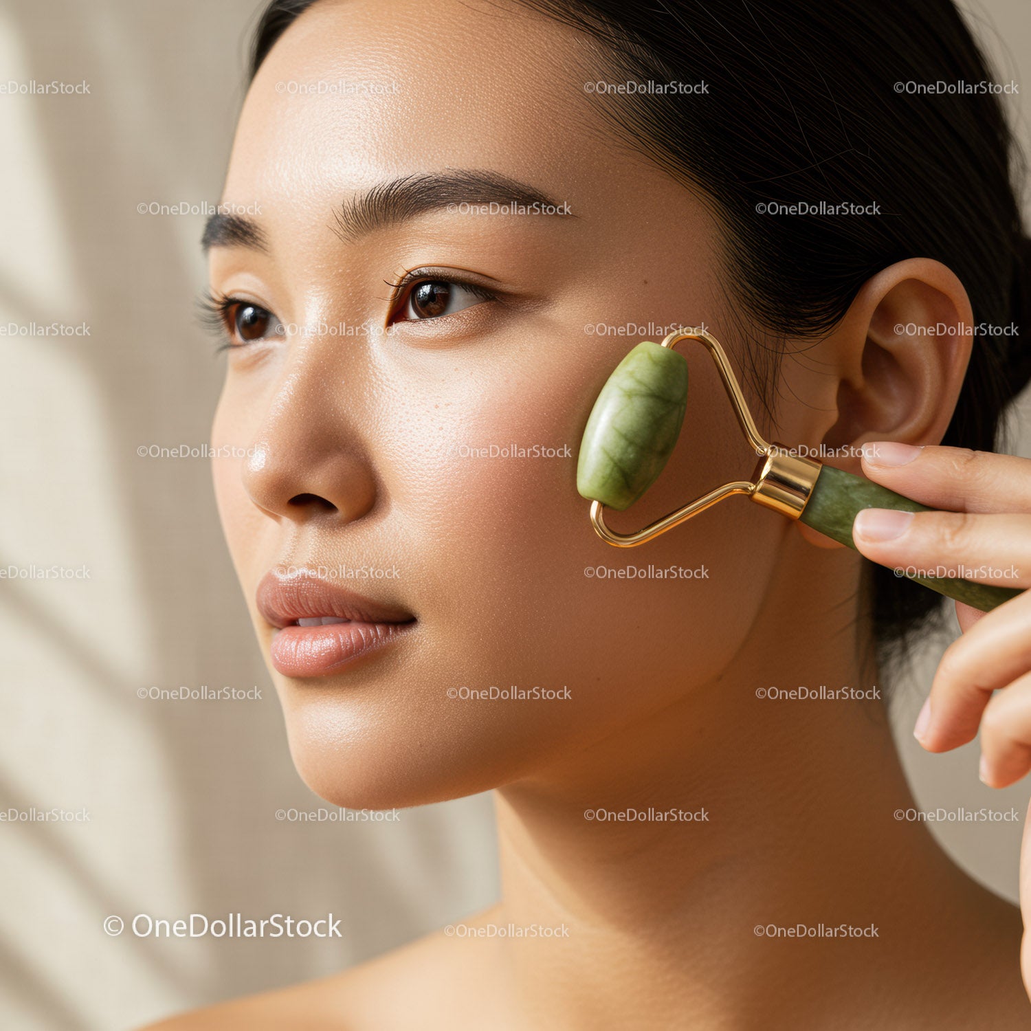 Close-Up of Woman Using Jade Roller for Facial Massage and Skin Rejuvenation