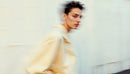Stylish Woman in Motion Wearing Elegant Beige Outfit