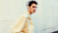Stylish Woman in Motion Wearing Elegant Beige Outfit
