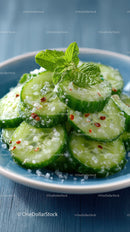 Fresh Cucumber Slices with Mint and Spices in a Blue Bowl