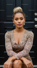 Confident young woman sitting by black door in patterned dress