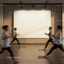 Women practicing yoga lunges in studio with blank wall art