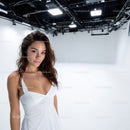 Beautiful Young Woman in White Dress in Modern Studio