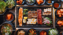 Korean barbecue with assorted meats and vibrant side dishes