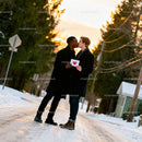 Couple Sharing a Tender Kiss Holding Valentine Card