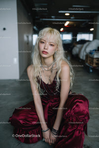 Stylish Young Woman in Velvet Dress and Silver Jewelry in Urban Setting