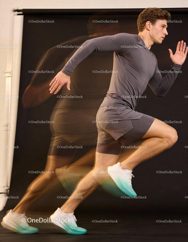 Athlete sprinting in dynamic motion against dark background