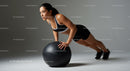 Athletic Woman Performing Push-Up with Medicine Ball in Gym