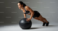 Athletic Woman Performing Push-Up with Medicine Ball in Gym