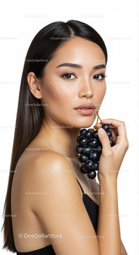 Elegant Woman Holding Black Grapes Face Close-Up Studio Portrait