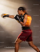 Focused young woman boxing with power and determination