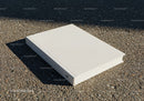 Minimalist white book laying on textured pavement