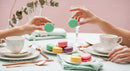 Elegant Pastel Macarons and Fine Tea Set for Stylish Brunch