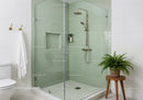 Modern glass shower with brass fixtures and green tiles