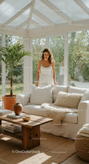 Woman in white dress in bright cozy sunroom