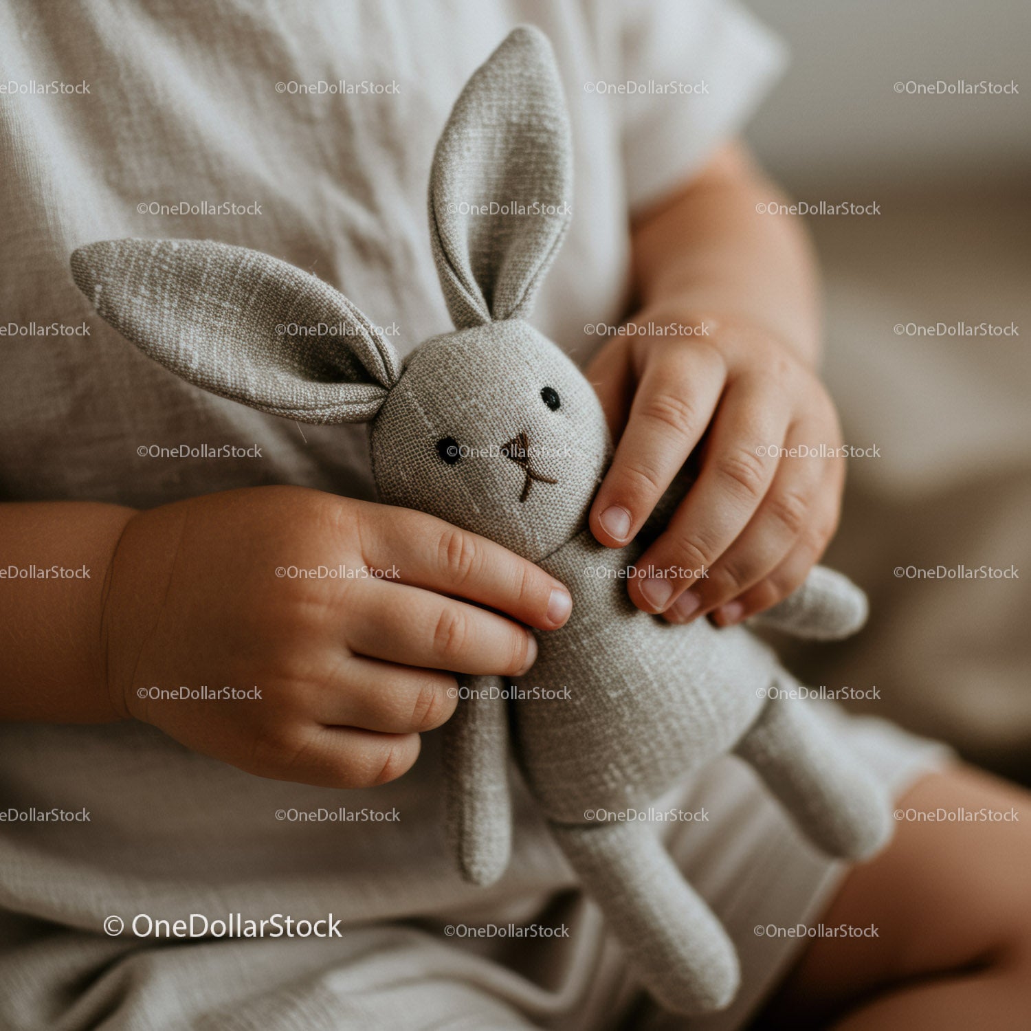 Toddler holding soft knitted bunny plush toy close