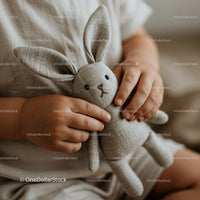Toddler holding soft knitted bunny plush toy close