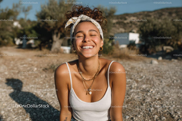 Joyful Young Woman Smiling Outdoors on Sunny Summer Day